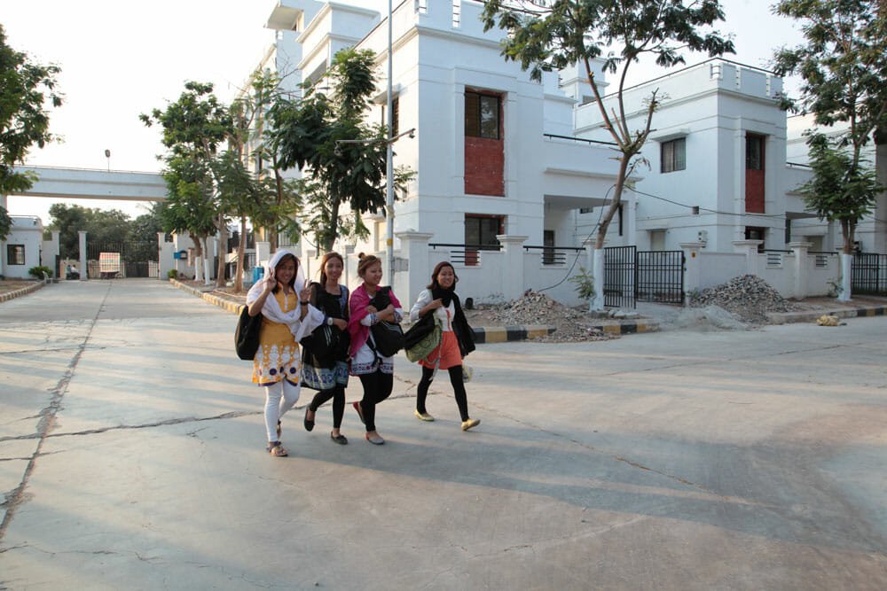 Girls hostel residents walking on campus near the hostel block